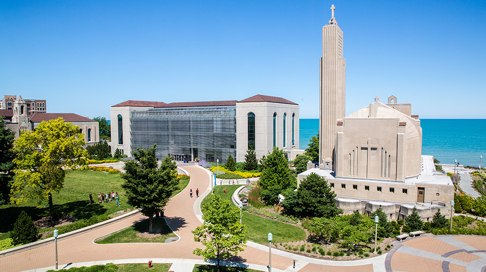 The Loyola University Chicago Lake Shore Campus quad on a sunny day with blue sk