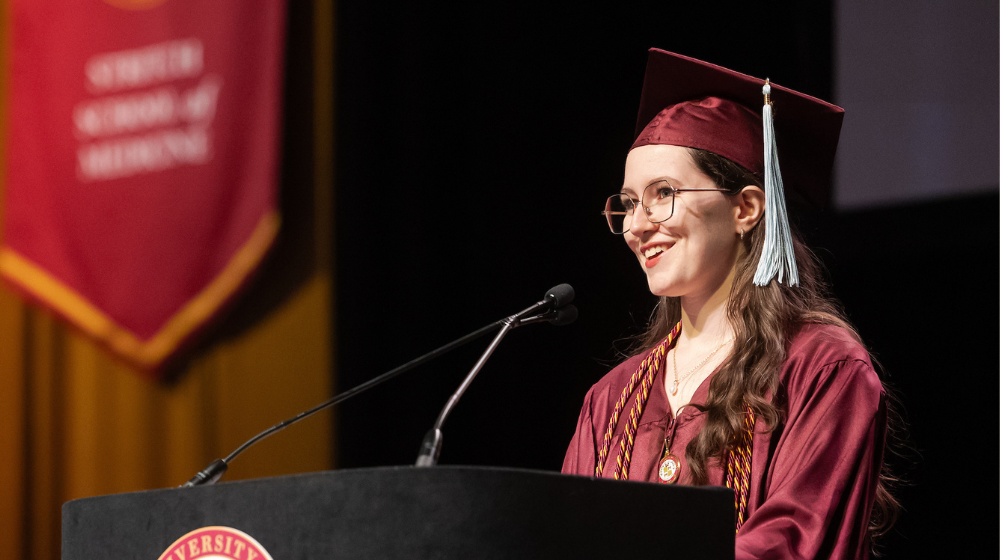 SOE Graduate and Commencement speaker, Elizabeth Usher standing at podium 