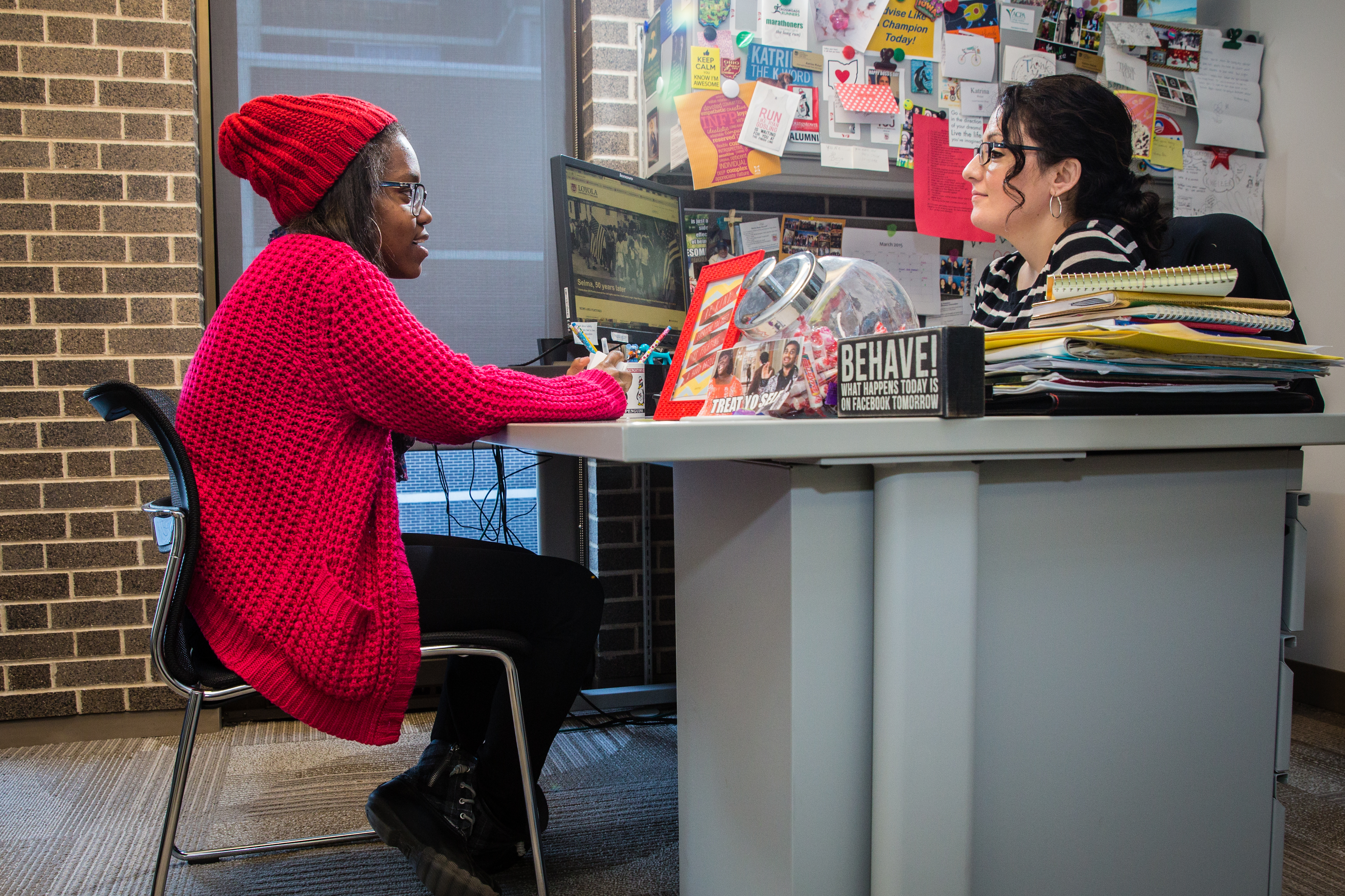 Keyona Castlemant (left) sits with her advisor during a meeting