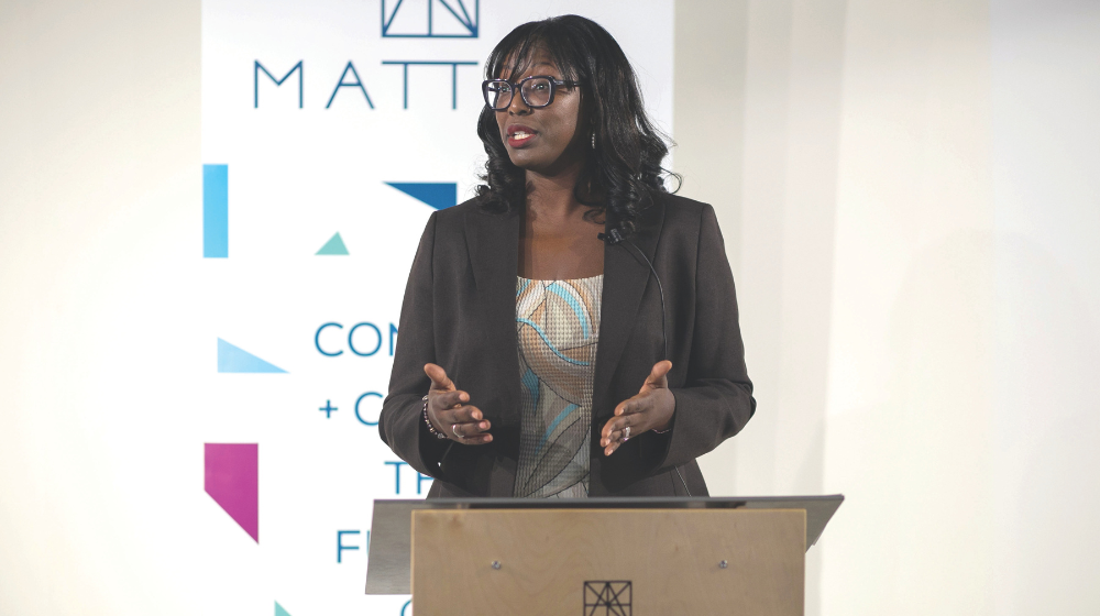 Woman speaking and standing behind podium