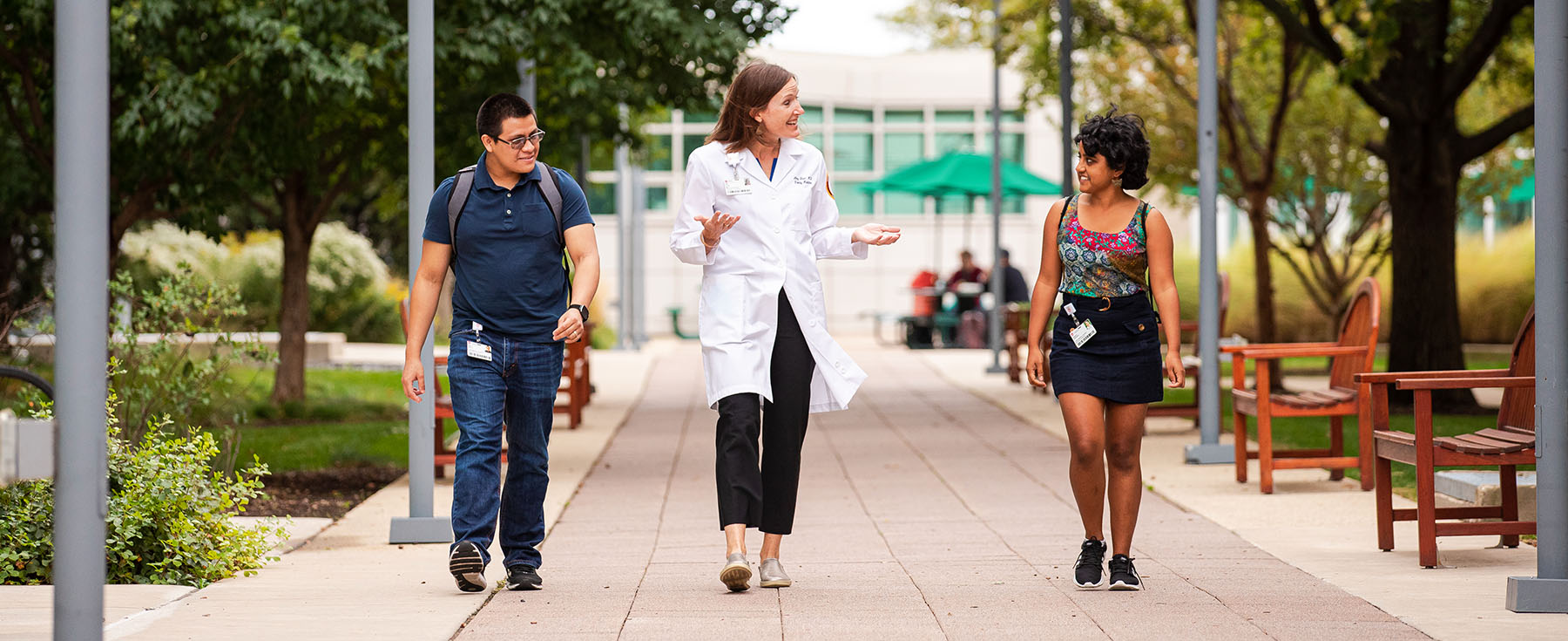 Dr. Amy Blair talks with students on the Health Sciences Campus.